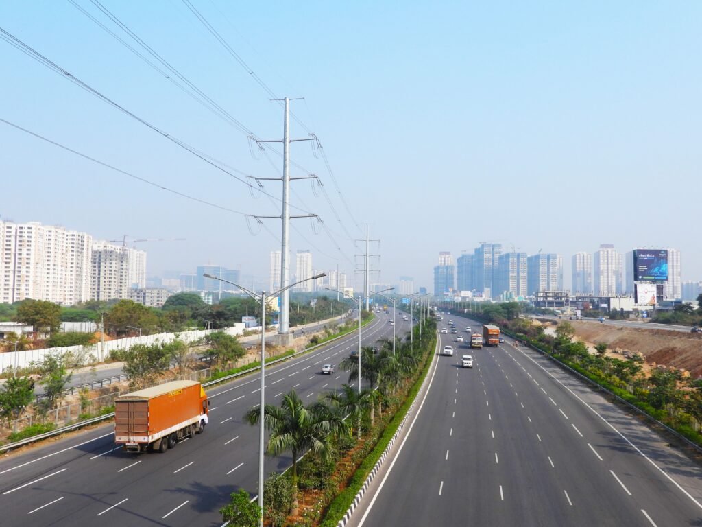 Wide-angle view of a busy city highway with traffic amidst high-rise buildings.